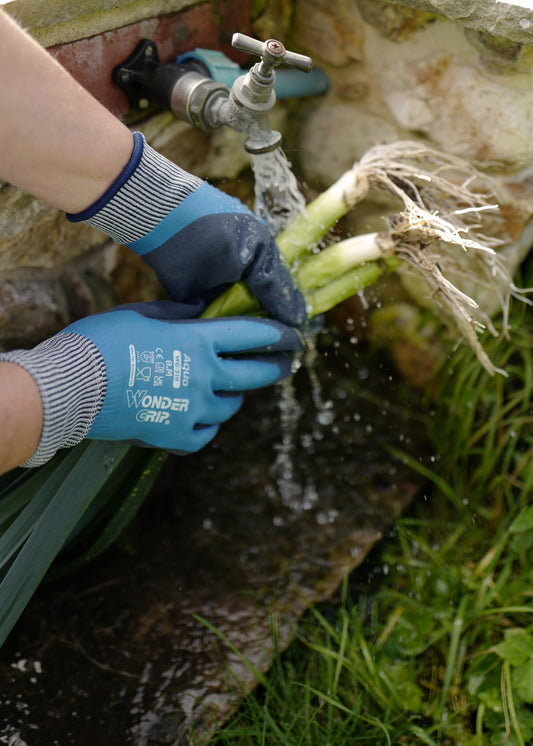 Waterproof gardening gloves with blue latex-coated palm and fingers, textured black grip, cushioned palm, and flexible knit wrist for wet outdoor work.